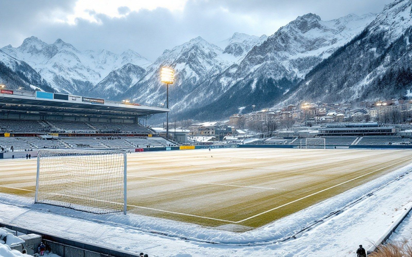 A snow-covered pitch with goal frames, wide and flat